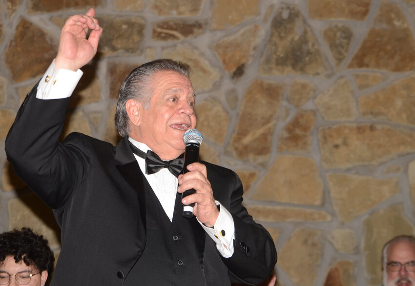 Jorge Marsal, conductor of The Joshua Experience big-band, greets guests from the stage. The 12-member band has entertained at all three Senior Prom and Gala fundraiser banquets.