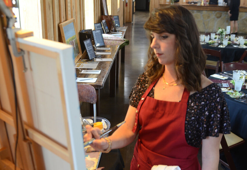 Kristen Soble has donated a live art auction item each year of the Senior Prom and Gala, painting during the event and auctioning the art when finished. This year's contribution was a boardwalk scene with a domestic sky.