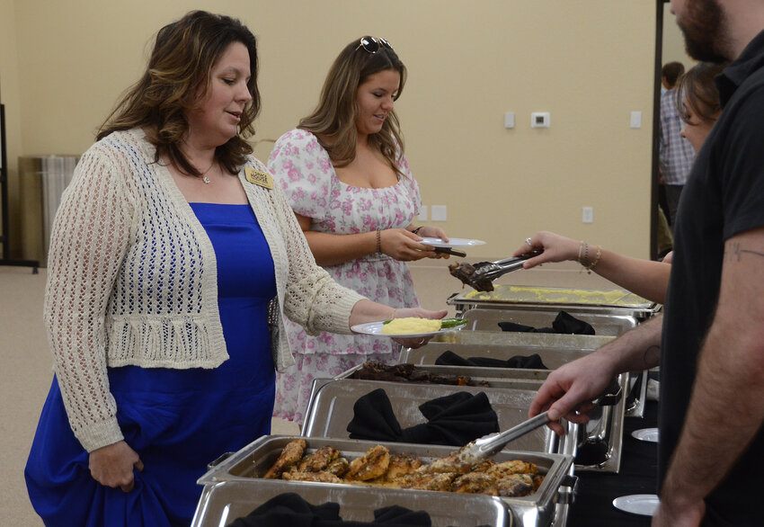 Grace House boutique superintendent Kathryn Perley and daughter Grace Perley enjoy the food service.
