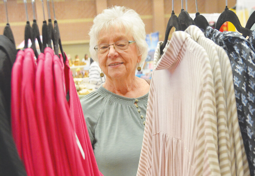 Gail Bagley admires colorful clothes at one of the Aledo High School Spring Fling’s 125 booths on Saturdday, March 29.