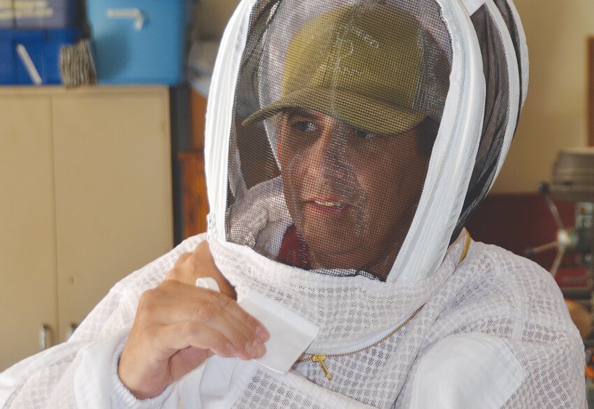 James Vasich dons a bee suit.