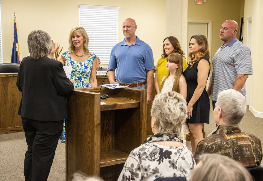 Teresa Palmer and her family stand as Palmer is sworn into office as the city of Willow Park's new mayor.
