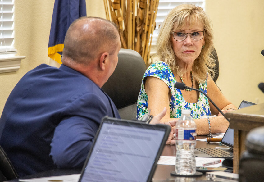 Mayor Teresa Palmer and City Administrator Bryan Grimes discuss a line item during the May city council meeting.