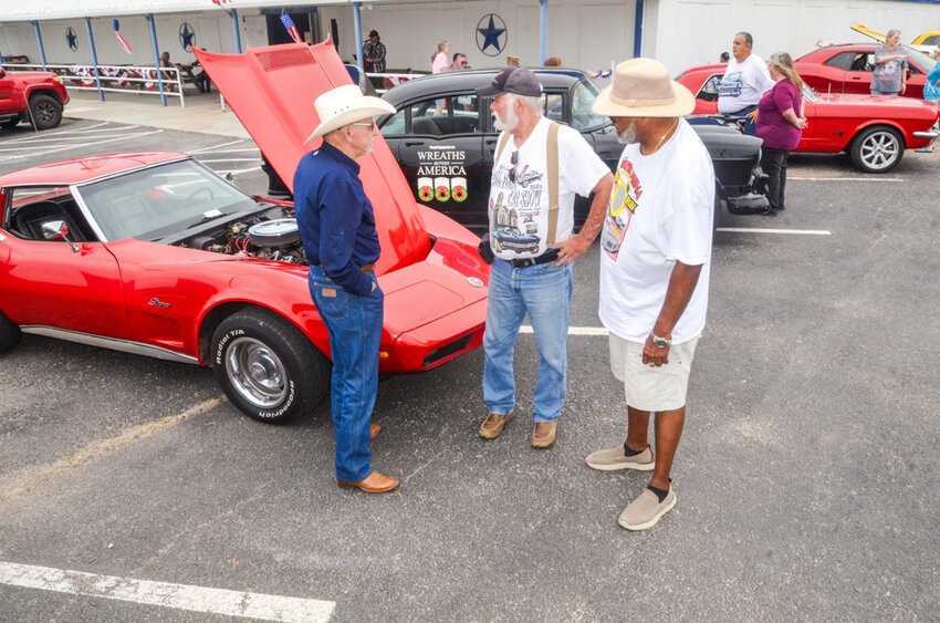 Three of Parker County Cruisers’ 80-plus members, Jackie Collins, Gary Peninger, and James Logan, shoptalk during a show at Westside Antiques Market, which is one of the club’s business sponsors.