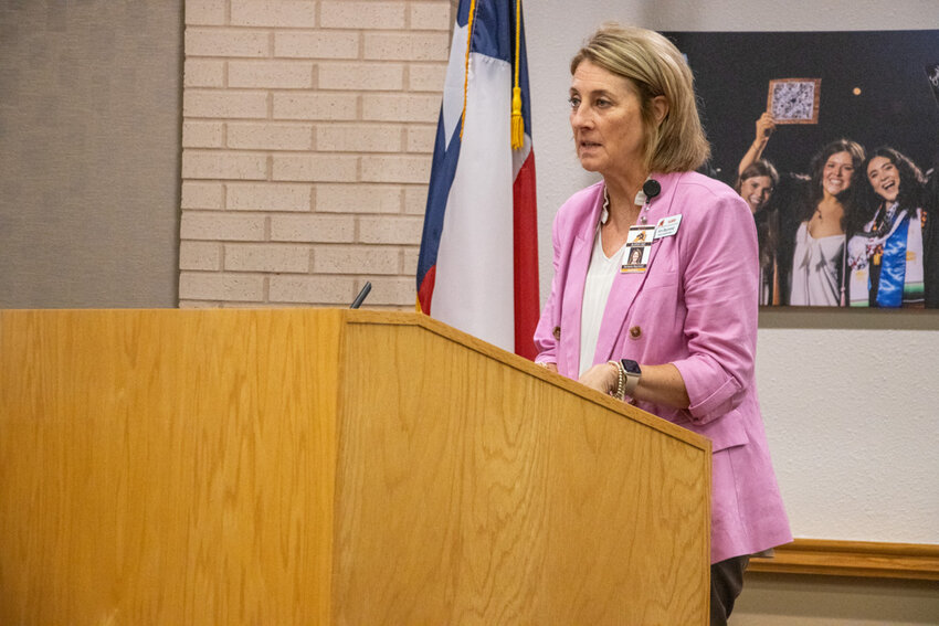 Deputy Superintendent Kim Raymond speaks to the board regarding the addition of seven staff positions.