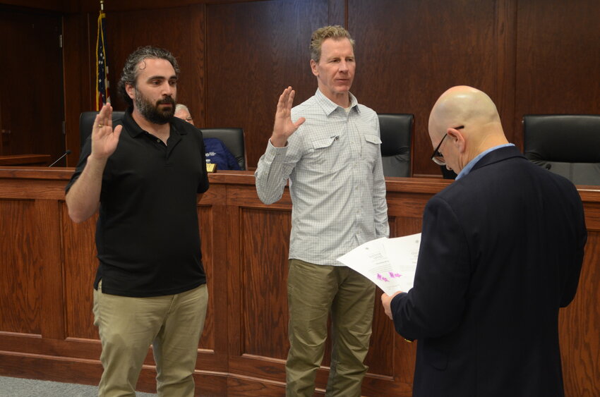 Daniel Cross, Place 5 and Sean Cannon, Place 4 take the oath of office for another term with Mayor Tom Fitzpatrick giving the oath of office.