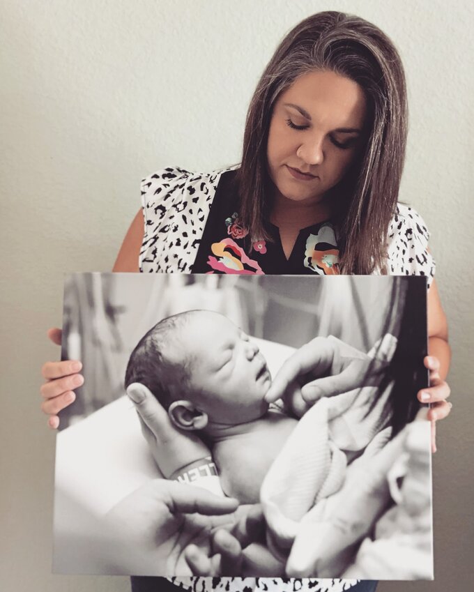 Peyton Lauderdale holding a photo of her son James.