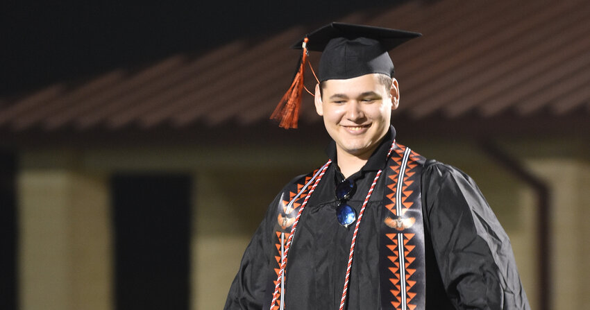 Hunter Gregory prepares to cross the stage in his Native American regalia at the Aledo High School graduation ceremony on May 24.