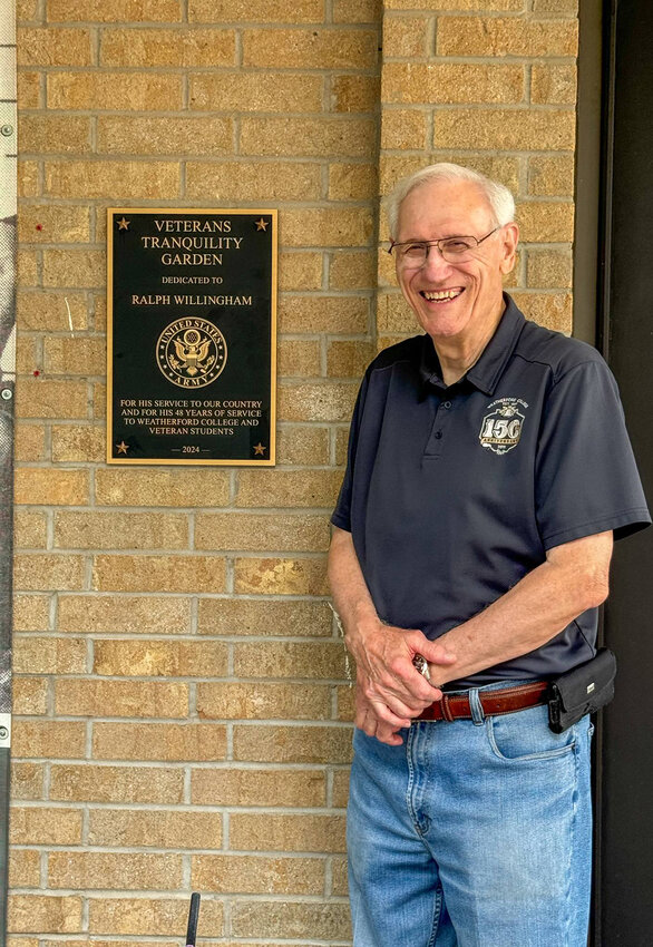 Ralph Willingham is shown with the plaque designating the Tranquility Garden in his honor at Weatherford College.