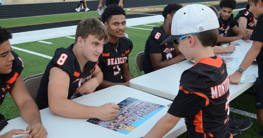 Walsh Elementary School second grader Hayes Montgomery get an autograph from Nash McElree.