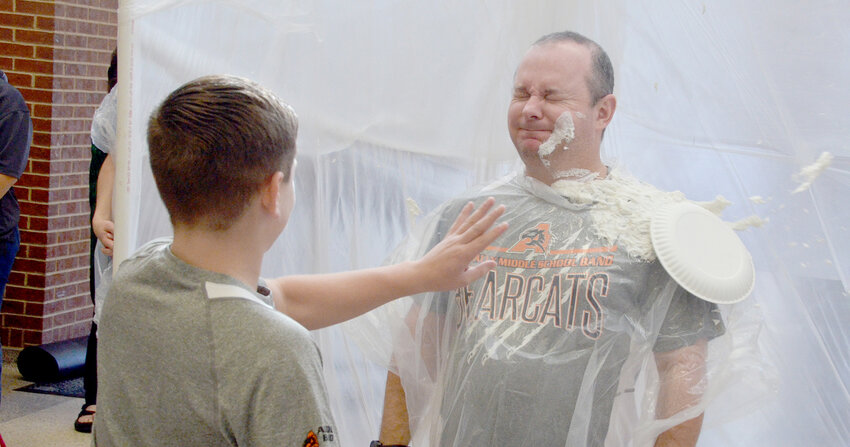 Adam Nichell creams middle school instructor Joey Qualls with a pie.