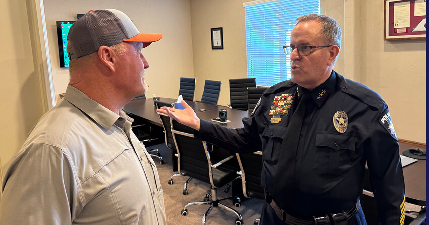 Jerry Stockon of Willow Park converses with new Willow Park Police Chief Ray Lacy at a 