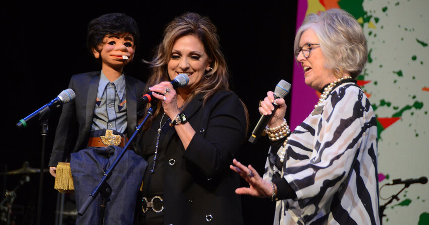 Bubba, ventriloquist Gloria Gilbert-Barron, and Jo Warren chat before Gilbert-Barron entertains supporters of Grace House.