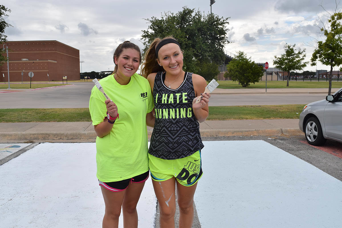 Emily Garner and Kaylie Taylor were hard at work this week painting their senior parking spaces at AHS.