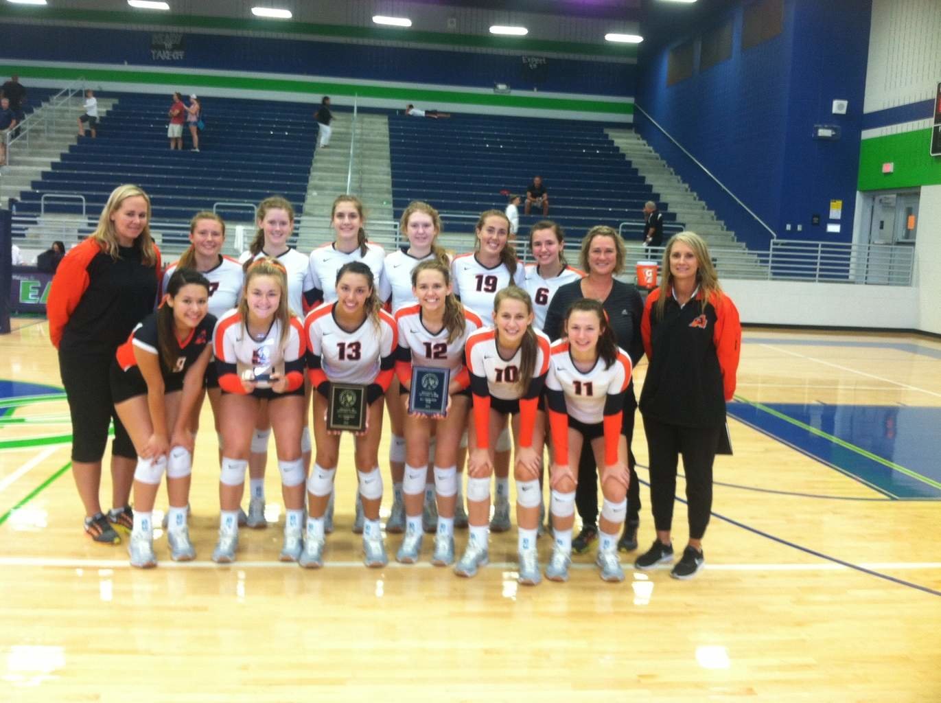Capturing second place at the Northwest Volleyball Classic were the Aledo Ladycats, who are gathered around their second-place trophy. Also holding awards are Maddie Goings (13) and Emily Smith (12) who were each selected to the all-tournament team.