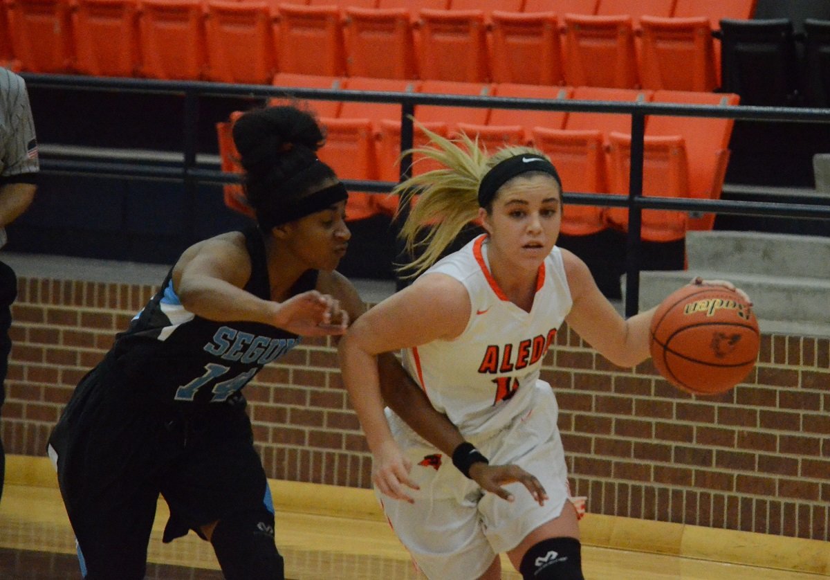 Aledo freshman guard Taylor Morgan (10) gets past Arlington Seguin guard Trinitee Cannon Thursday morning during the Ladycats' 51-45 loss to the Lady Cougars at the Aledo High School gym. Morgan led all scorers with 20 points. The Ladycats will be back in action this afternoon with a 3 p.m. tip off against Plano Home School. The tournament runs through Saturday.