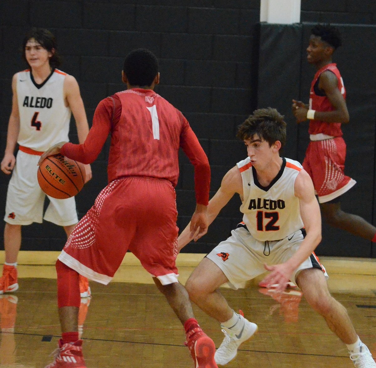Aledo junior guard Cameron Yates (12) puts pressure on a Terrell guard Tuesday night during the Bearcats' 54-42 loss to the Tigers. Photo by Tony Eierdam.