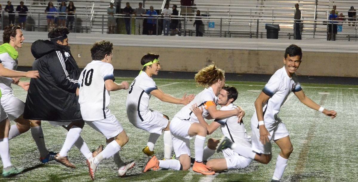 The Aledo Bearcats celebrate after defeating rival Arlington Heights in an overtime shootout Friday night in an area playoff match at Bearcat Stadium. Photo by Tony Eierdam