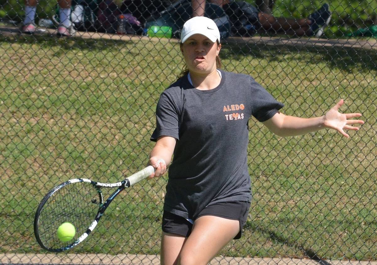 Aledo senior Nikki Adamie returns a serve during mixed doubles Monday morning during the District 6-5A tennis tournament at TCU. Adamie and her playing partner, Alec Meendsen, won twice on Monday and will play in the championship match Tuesday at TCU. Photos by Tony Eierdam