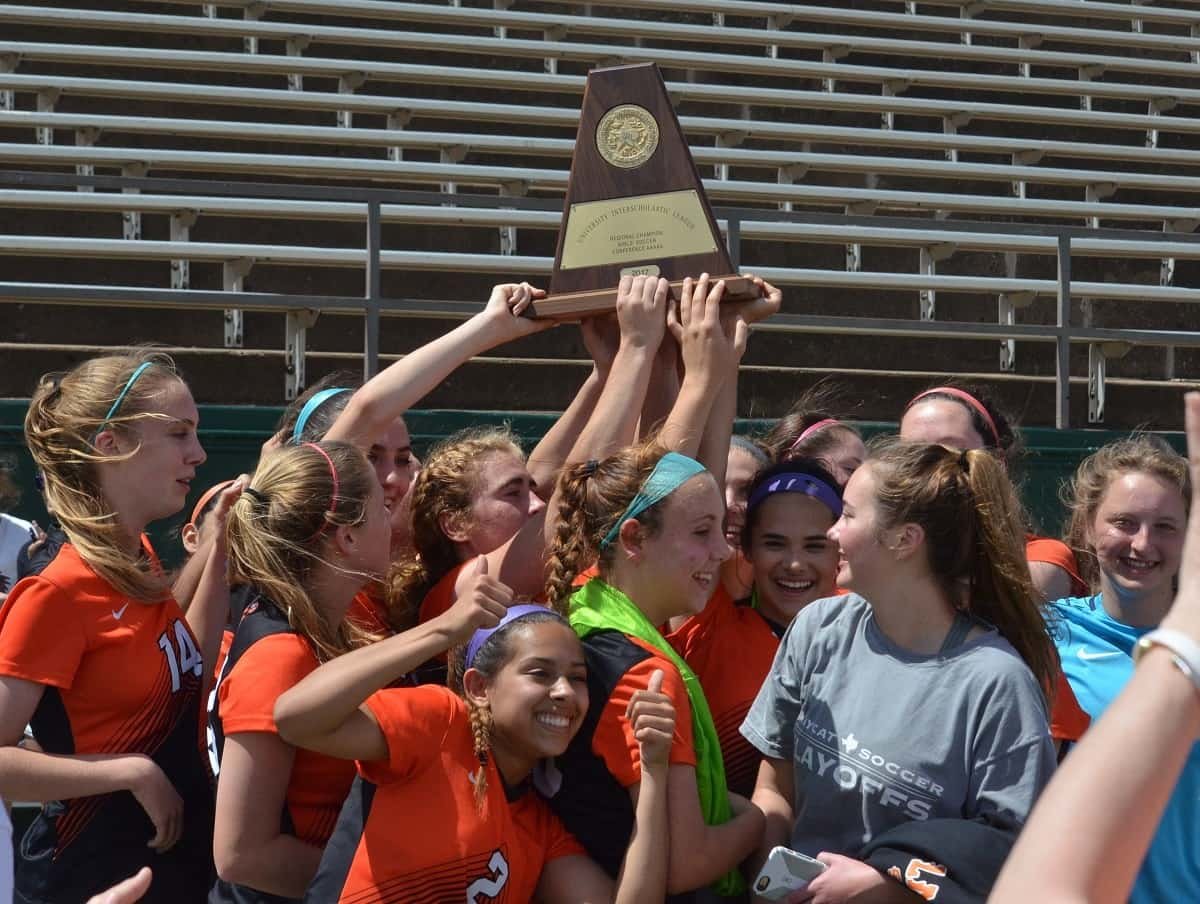 The Aledo Ladycats hold up their plaque earned after winning the Class 5A, Region I championship after a 3-0 victory over No. 3 Lubbock Monterey Saturday afternoon at Memorial Stadium in Wichita Falls. The win earns the Ladycats their first trip to the state tournament. Photo by Tony Eierdam