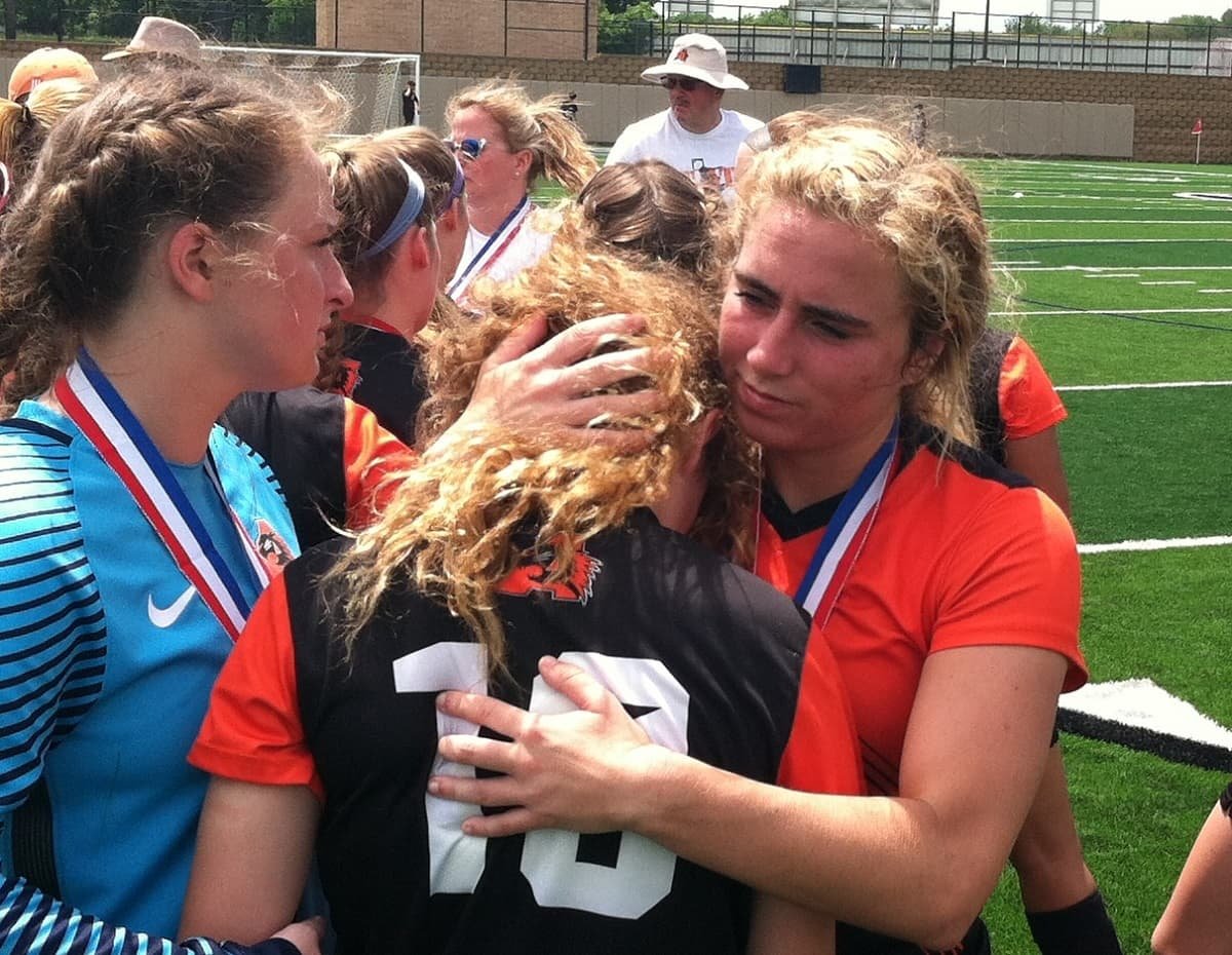 Aledo senior Cameron Huddleston hugs her sister Cheney moments after the Ladycats fell 5-3 to Highland Park Saturday afternoon in the girls' Class 5A state championship match at Georgetown. Photos by Tony Eierdam