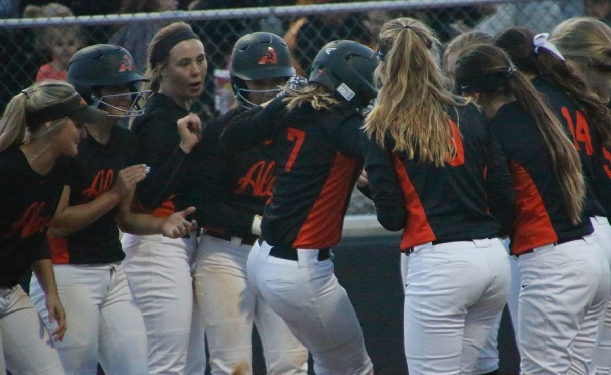 Aledo shortstop Mykayla Stroud (7) is mobbed by teammates after hitting a home run in the Ladycats' 14-3 win over Denison Wednesday night at Denison. Stroud recorded five hits, including two homers, and drove in four runs. Photo by David Andrews