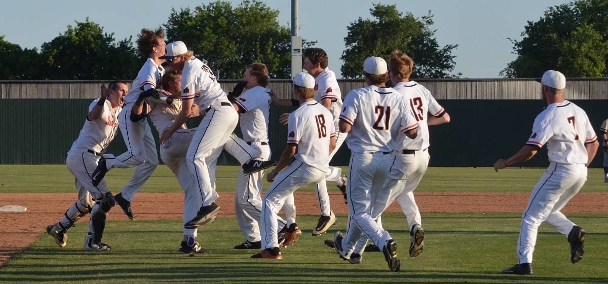 Aledo first baseman Jacob Arizpe is mobbed by teammates after his two-run hit drove in the winning runs as the Bearcats won in walk-off fashion, 9-8, over Denton in the opening game of a best-of-3 bi-district playoff series.
