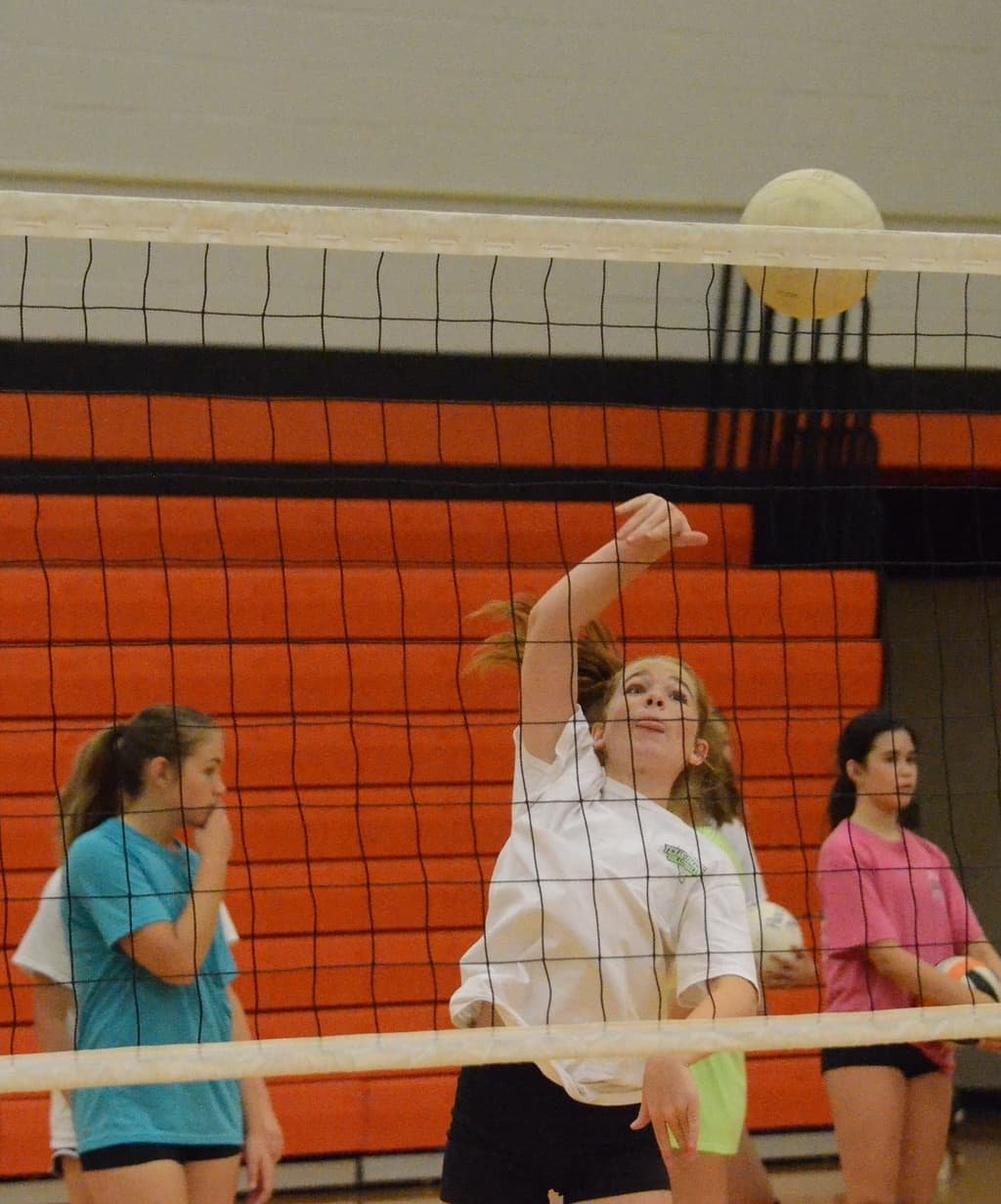 Kennedy McCullough sends down a kill during a hitting drill Tuesday morning at the Ladycats Volleyball Camp at the Daniel Ninth Grade Campus gym. Photo by Tony Eierdam
