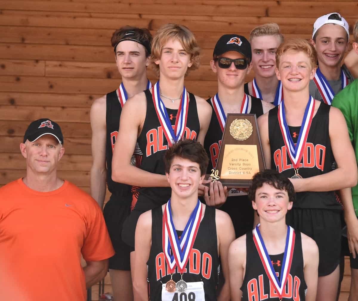 The Aledo boys' cross country team of Graydon Morris, Avery Tilley, Cooper Goggins, Trevor Connelly, Jake Bettinger, Richard Reynolds and Ryan Shaffer finished in second place as team at the District 6-5A meet today to qualify for the regional meet in Lubbock. Morris finished first in the boys' race to capture his second 6-5A cross country championship. Also shown is head coach Mike Pinkerton. Photos by Tony Eierdam