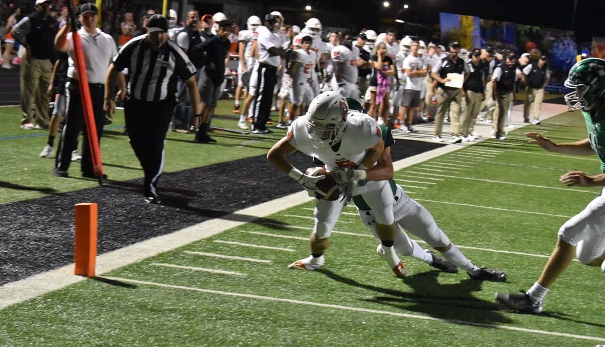 Aledo senior receiver Hunter Rosson drags a defender before crossing the goal line on a seven-yard touchdown pass from Jake Bishop Friday night during the Bearcats' win at Azle. Photos by Tony Eierdam