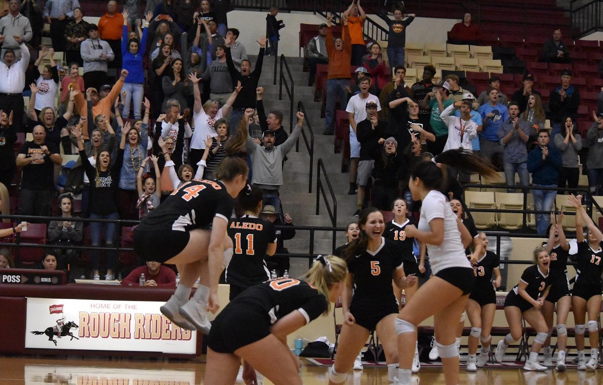 The Aledo Ladycats celebrate after defeating Grapevine in five games to win a Class 5A regional quarterfinal match Tuesday night at Saginaw High School. The win advances the Ladycats to the regional tournament in Abilene. Photos by Tony Eierdam