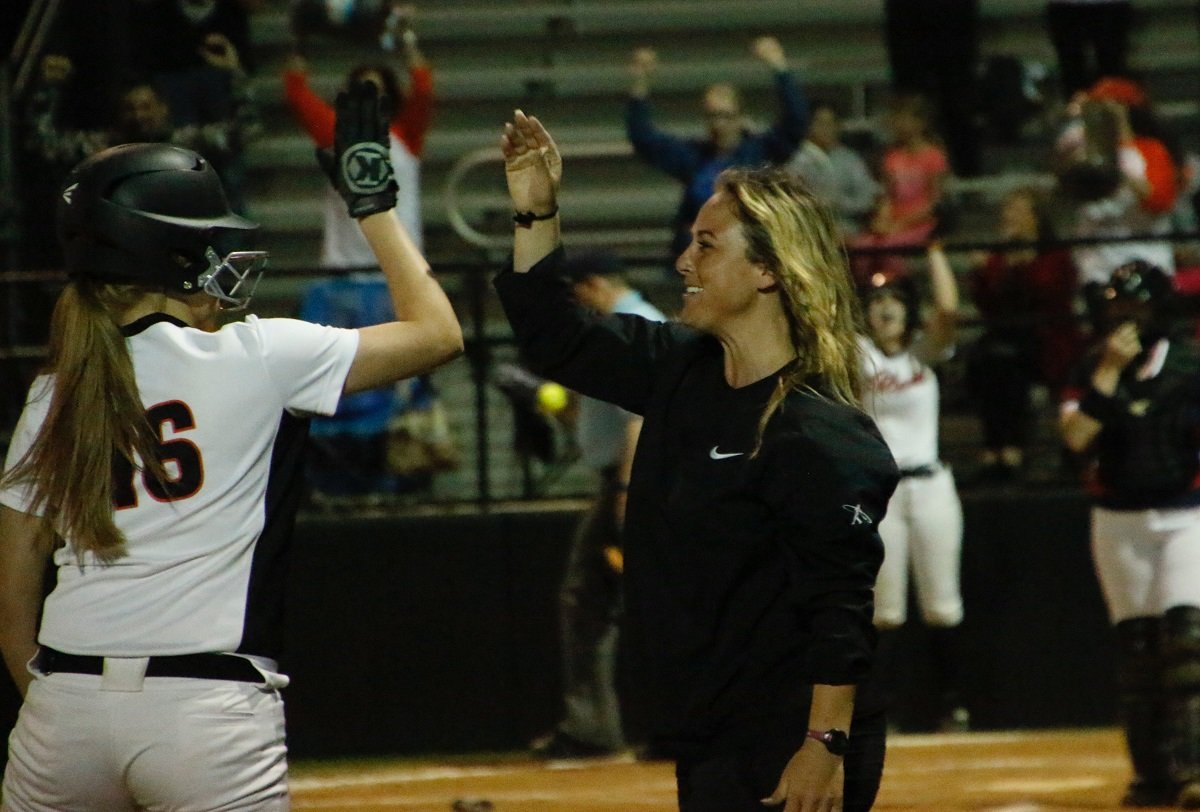 Aledo head softball coach Heather Myers high-fives Alana Smith after Smith's game-winning hit gave the Ladycats a walk-off, come-from-behind 5-4 victory over Northwest Friday night in a District 6-5A game at Aledo. Photo by David Andrews