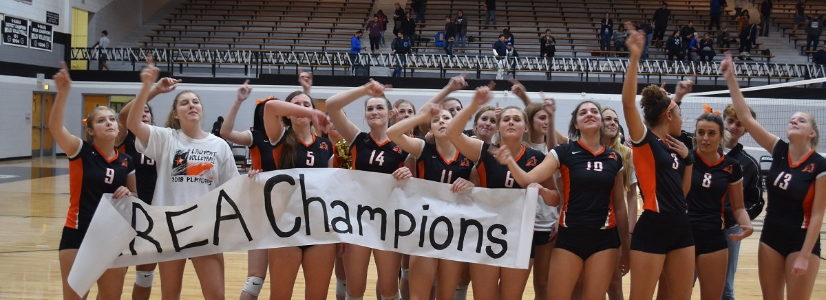 The Aledo Ladycats sing the alma mater while saluting their loyal fans who traveled to Odessa Friday night to watch Aledo beat El Paso Chapin, 3-1, in an area playoff volleyball match at Permian High School. Photo by Tony Eierdam