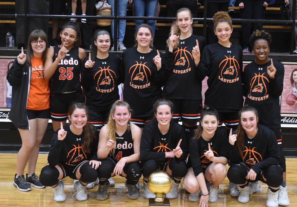 The undefeated 2019 District 4-5A champion Aledo Ladycats pose with their championship trophy following their 56-28 win Tuesday night at Wichita Falls Rider High School. Photo by Tony Eierdam