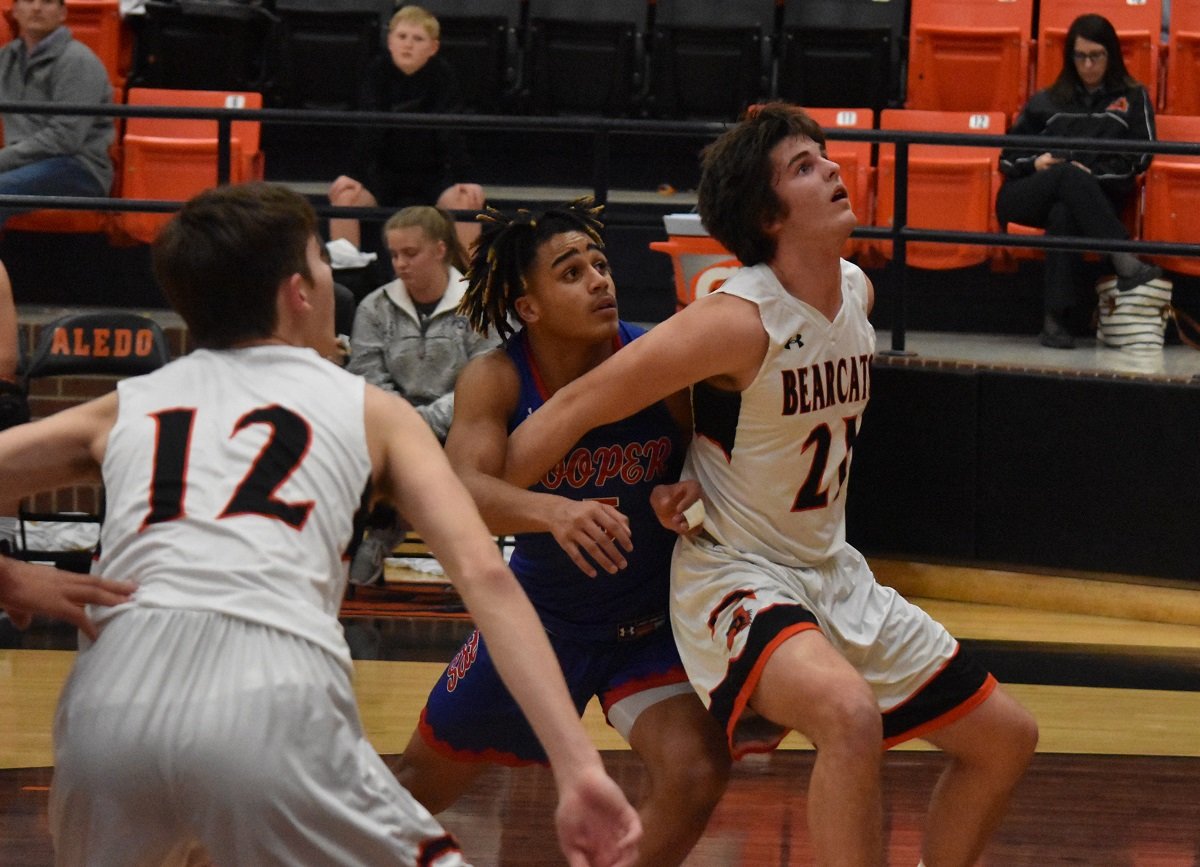 Aledo post Cole Nitsch (21) blocks out underneath as Max Newell (12) gets into position during a recent game. The playoff-bound Bearcats concluded district play Friday night with a 48-37 loss at Abilene Cooper.