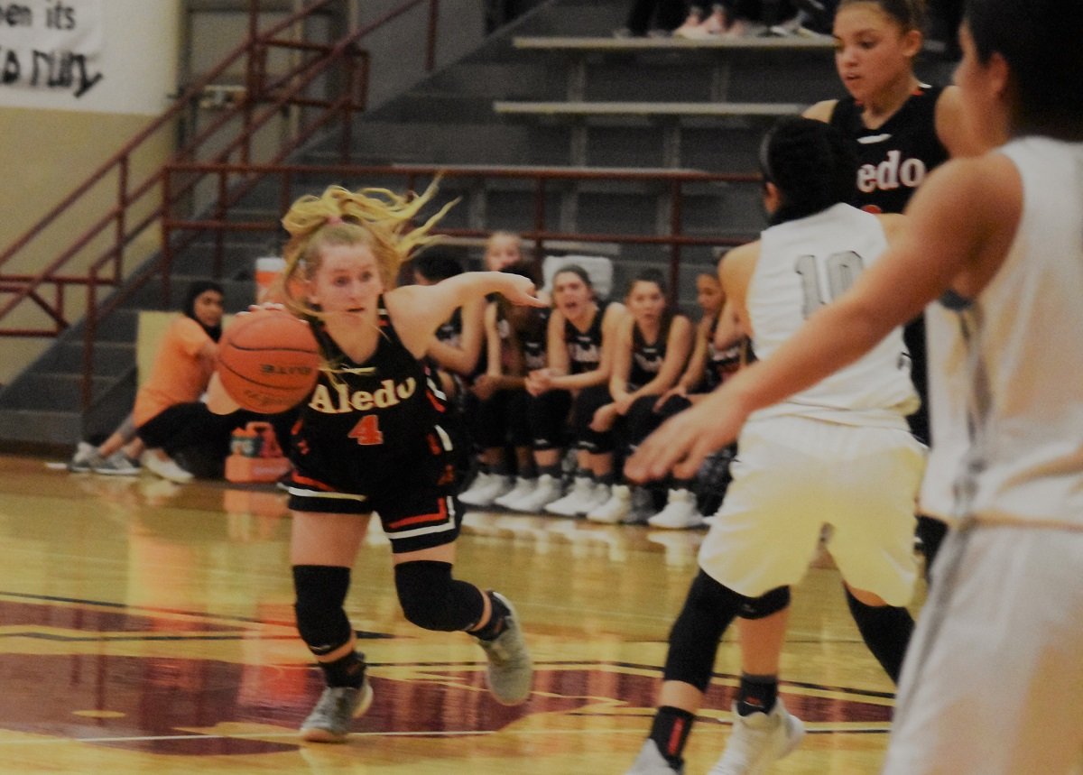 Aledo guard Riley Sale (4) attacks the lane during the Ladycats' win over Canyon Randall Monday night at Vernon in a bi-district playoff game. Photo by Tony Eierdam