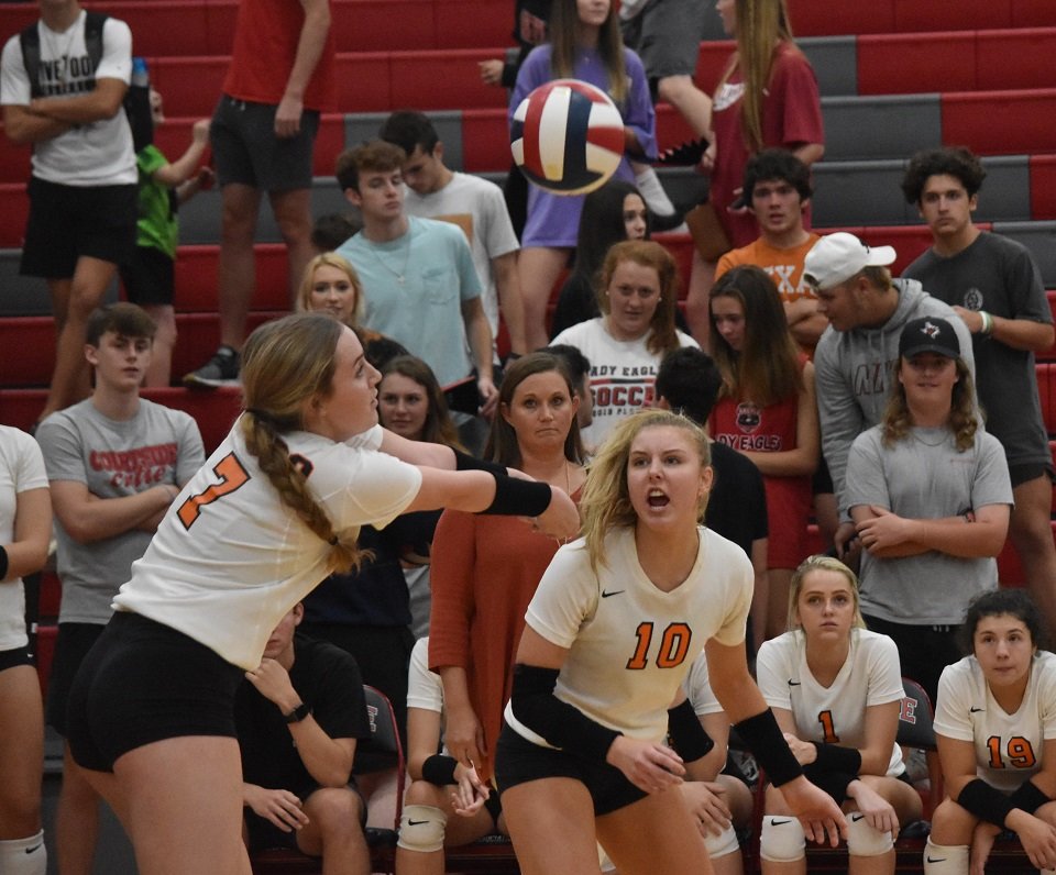 Aledo senior defensive specialist Jace' Parker (7) digs a ball as Alex Grooms (10) gets into position Tuesday night during the Ladycats' loss at Argyle. Photo by Tony Eierdam