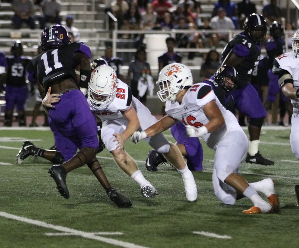 Aledo defensive end Caden Anderson (29) takes down Everman ball carrier Davonte Bisco (11) as linebacker Weston Reese (16) helps out during the Bearcats' 42-13 victory over the Bulldogs Friday night at Everman. Photo by Cynthia Llewellyn
