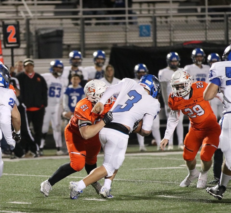 Aledo junior defensive tackle Oliver Crow (61) sacks Joshua quarterback Nyke Martin during the Bearcats’ victory over the Owls Friday night at Bearcat Stadium. Photo by Cynthia Llewellyn