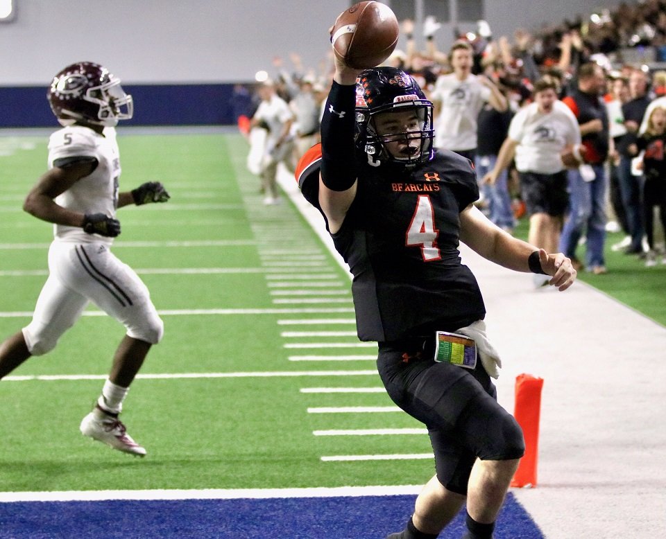 Aledo senior quarterback Jake Bishop scores on a 17-yard run for what would turn out to be the game-winning points during the Bearcats’ 43-36 overtime victory over Ennis Friday night in the Class 5A, Division II, Region II final at The Star in Frisco. Photo by Cynthia Llewellyn