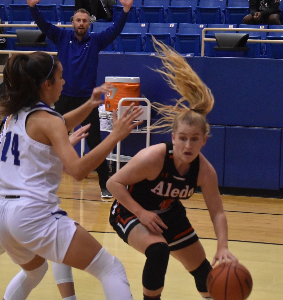 Aledo senior point guard Riley Sale (4) drives the baseline during the Ladycats' 47-44 loss Tuesday night at Fort Worth Nolan Catholic. Sale led all scorers with 19 points. Photo by Tony Eierdam