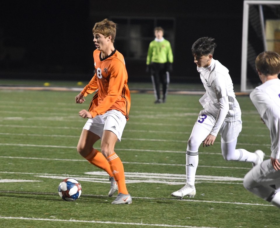 Aledo junior midfielder Dylan Dobransky (8) dribbles past a pair of Abilene Wylie defenders Wednesday night during the Bearcats' 4-0 win. Dobransky scored two goals and added an assist. Photo by Tony Eierdam