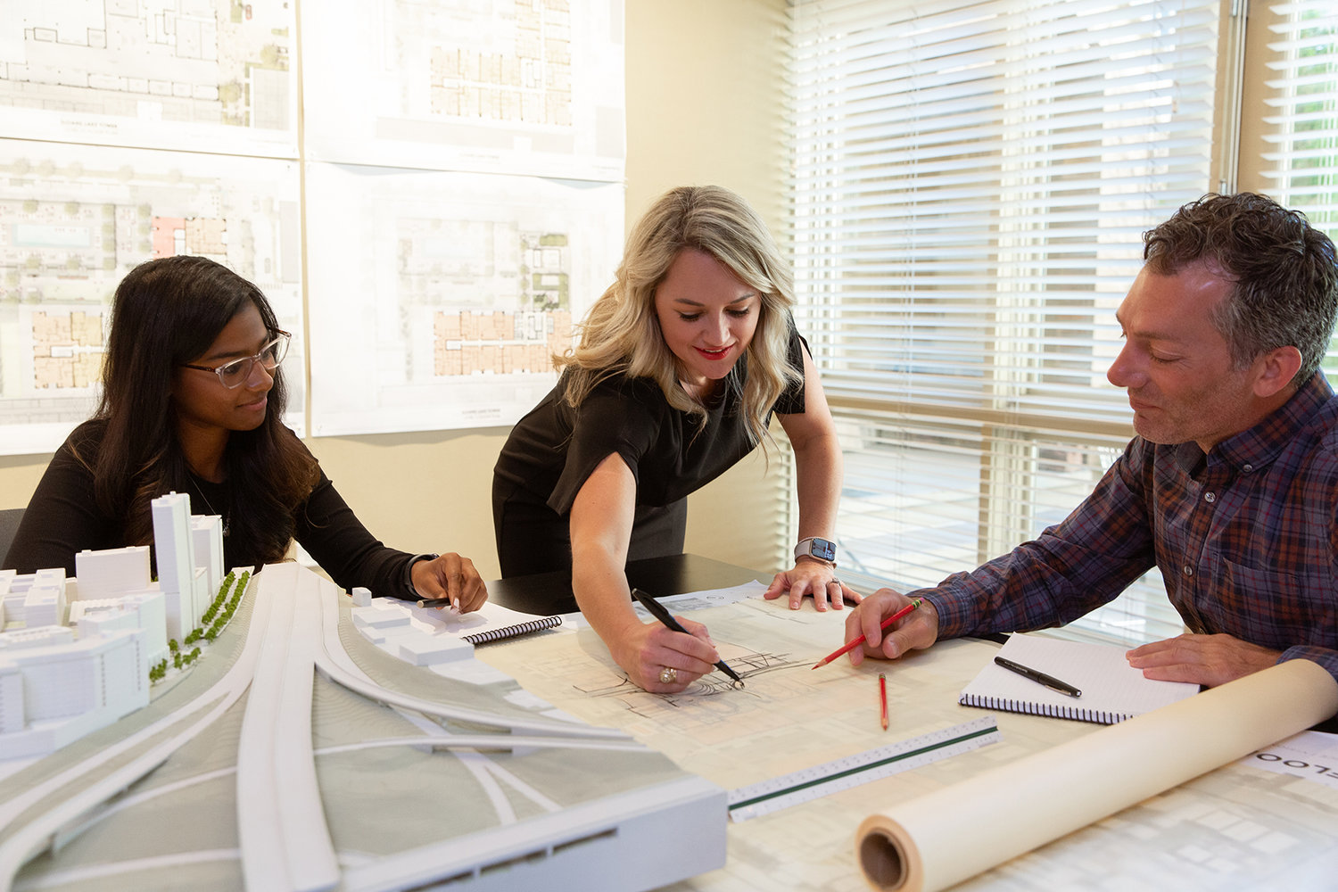 Shannon Bearden (center) goes over plans with Varini Nathany (left) and Salvatore Buccellato in Tryba's Denver office.