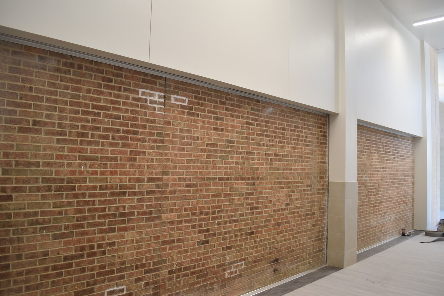 The exterior of the existing building made a durable interior wall in the new addition.