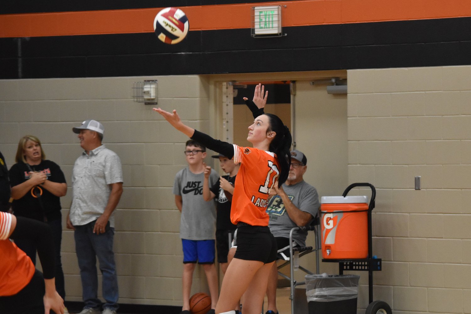 Rylee Metts serves to open the Ladycats volleyball season