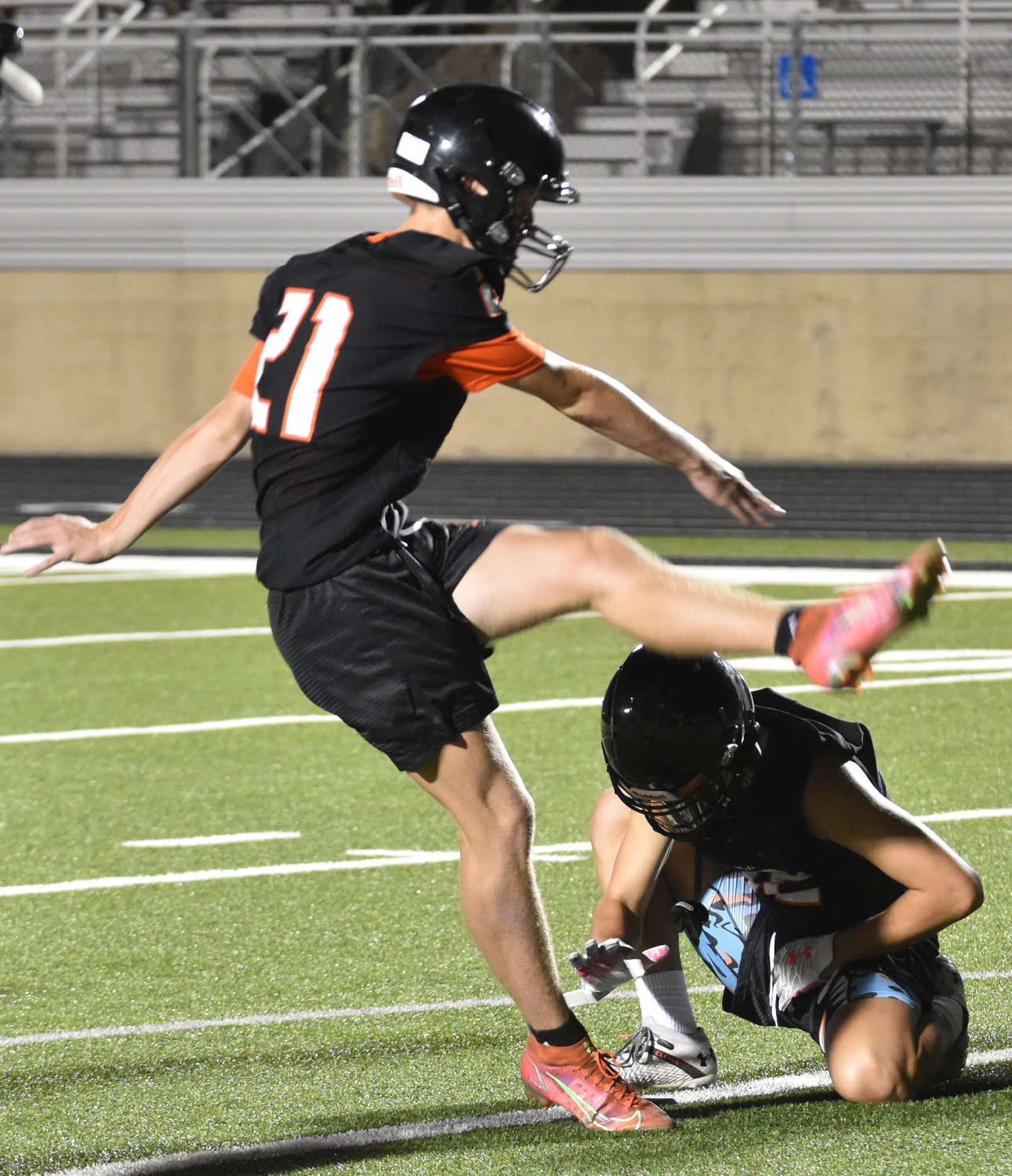 Sophomore Cole Crawford practices kicking extra points.