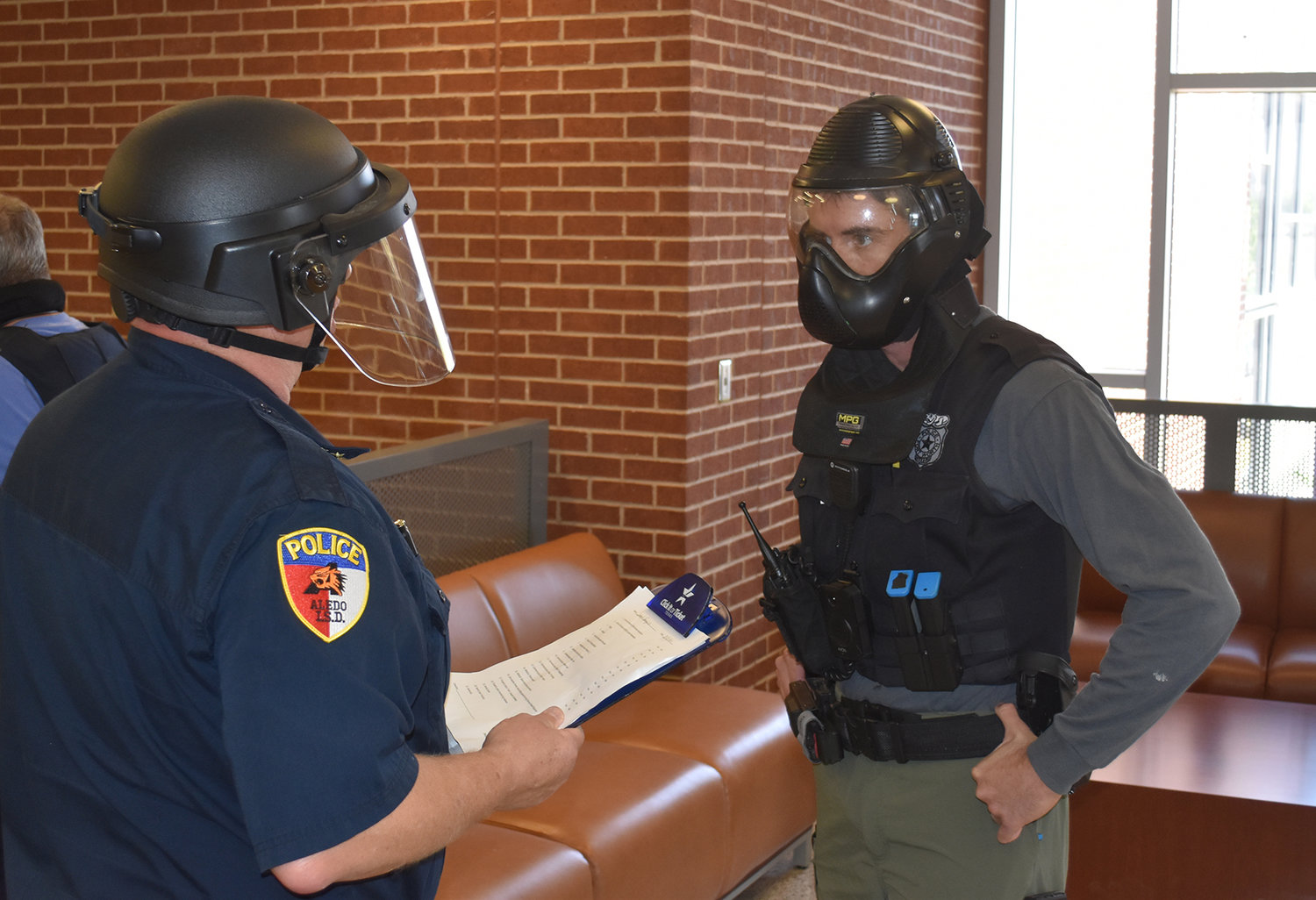 Aledo ISD Police Chief Fred Collie gives scenario training to Fort Worth Police Department Officer Juan Villagomez.