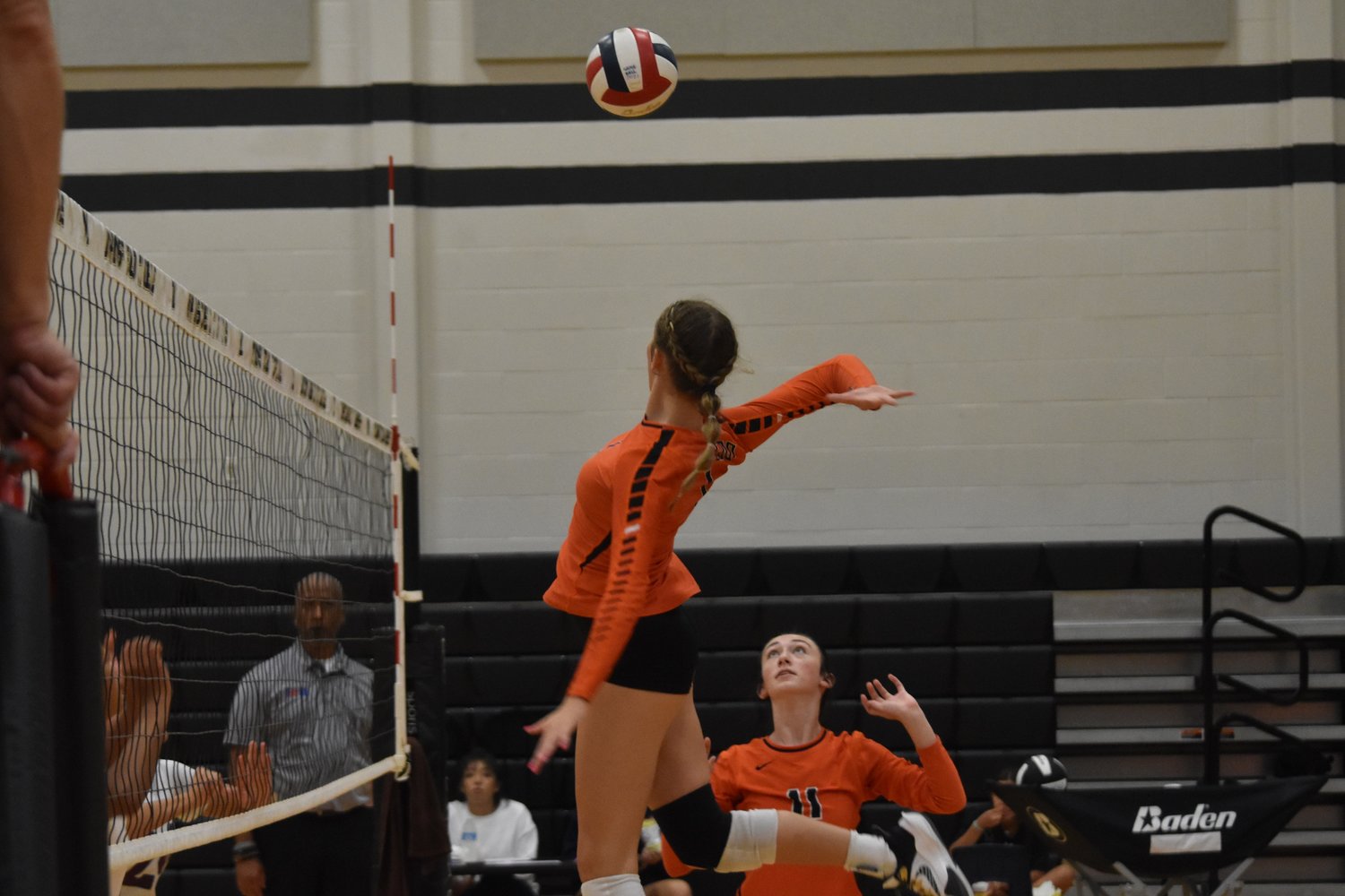 Maddie Frank leaps for the kill after Rylee Metts (11) sets her up