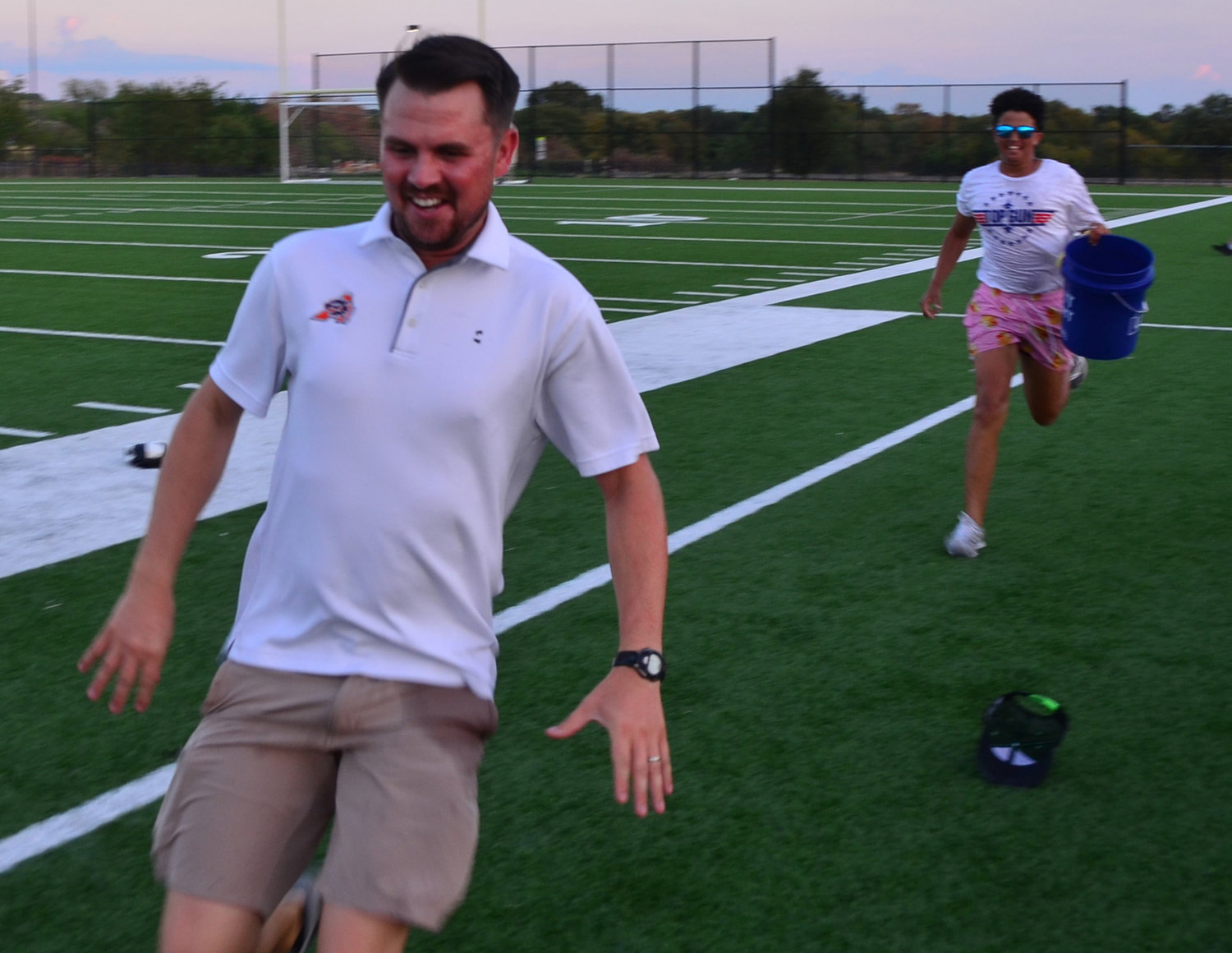 Band director Dexx Moore showed his speed on the turf by narrowly escaping a bucket of water but was later fenced and drenched by a dozen band members.