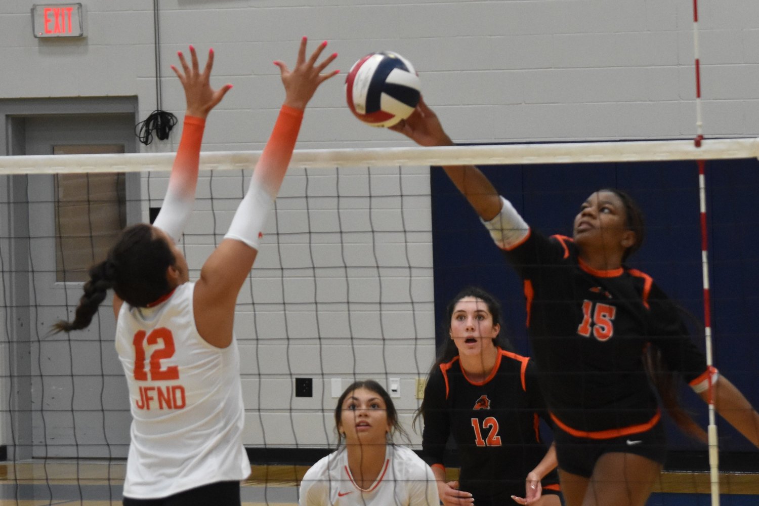 Lauryn Mack taps the ball over the net against Rockwall